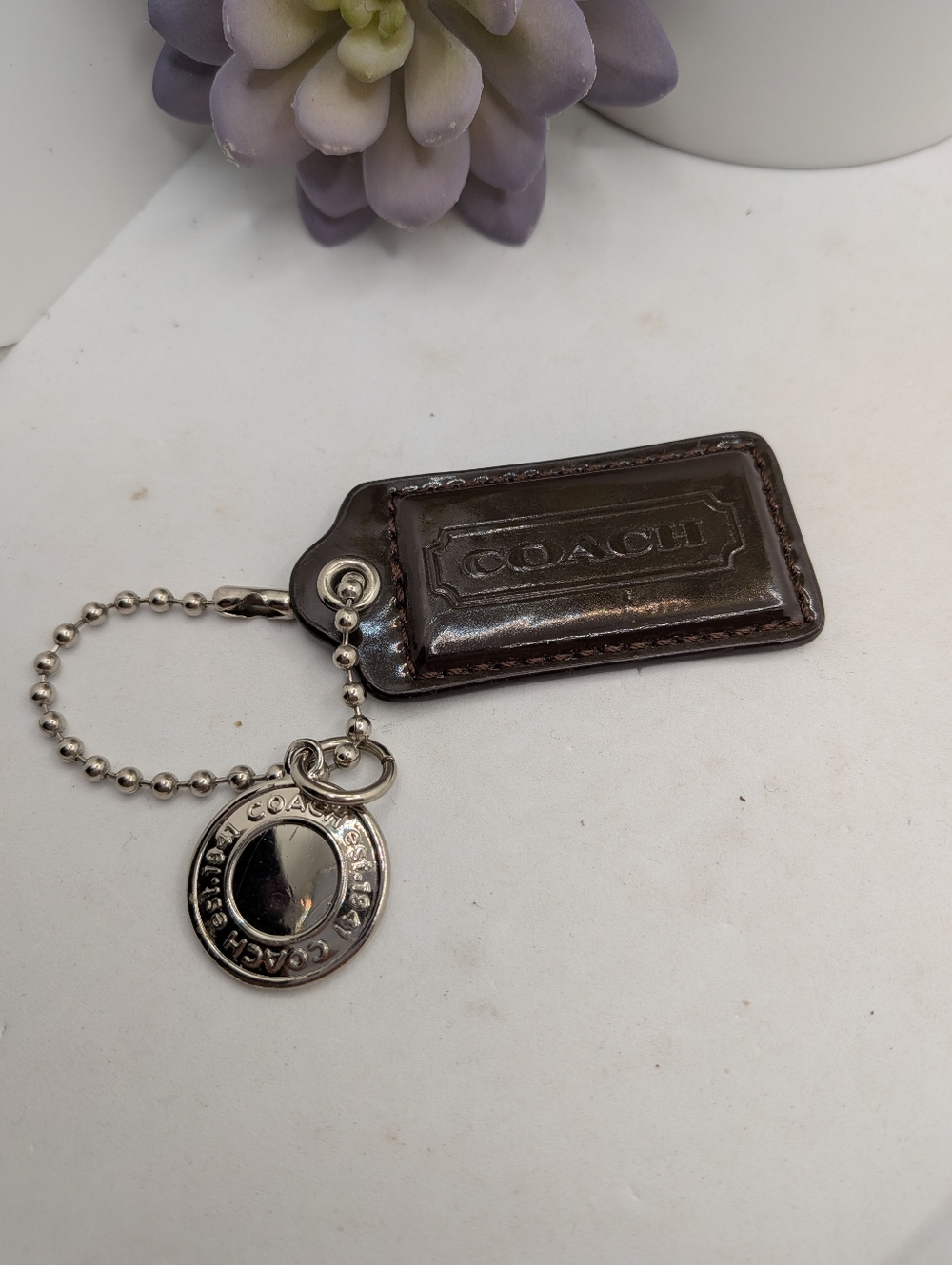 Coach brown Patent Leather Hang Tag  with Silver Medallion